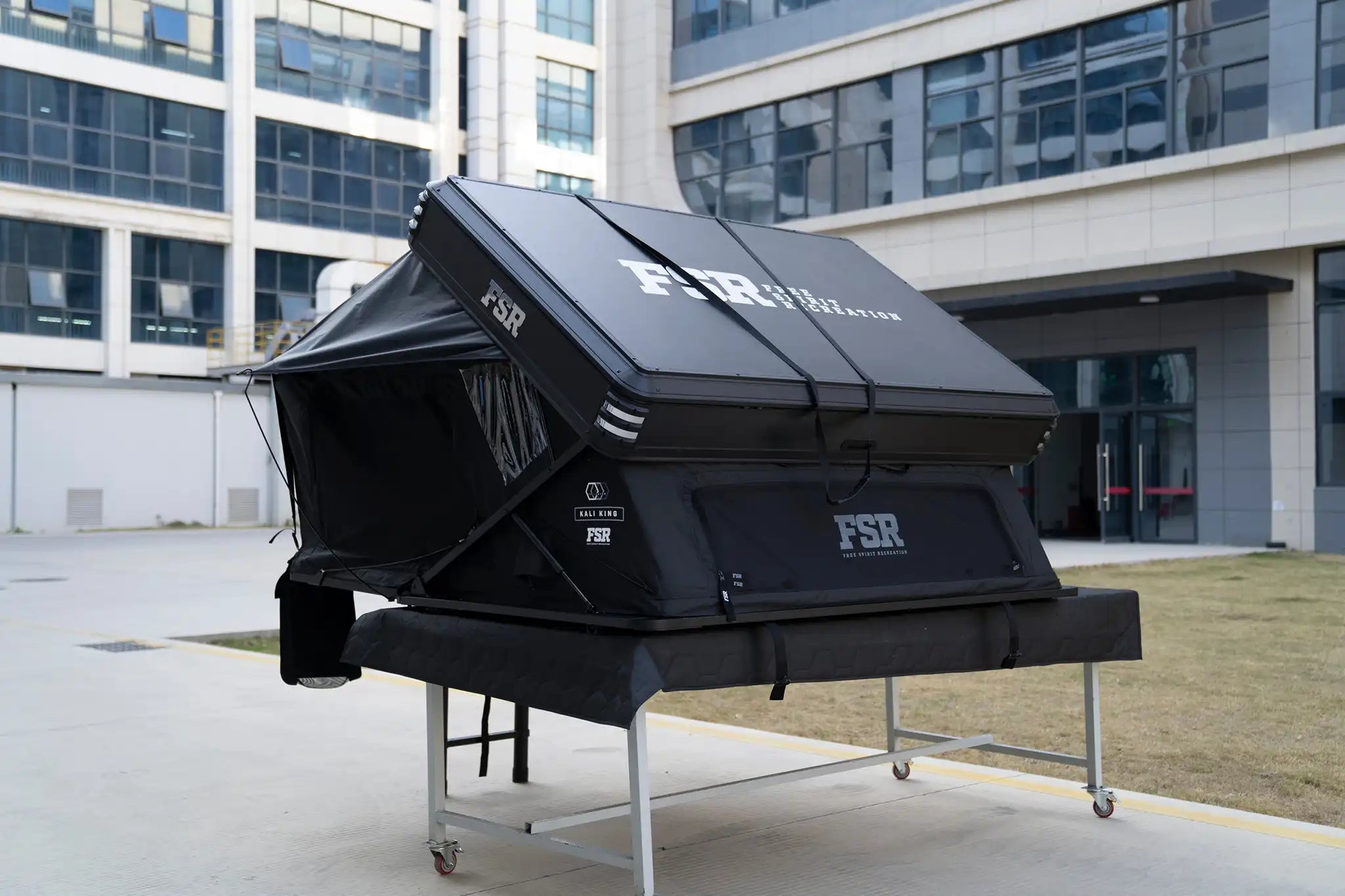 45 degree angle image of the right side and back of the Kali King hard shell rooftop tent from Freespirit Recreation open with windows closed