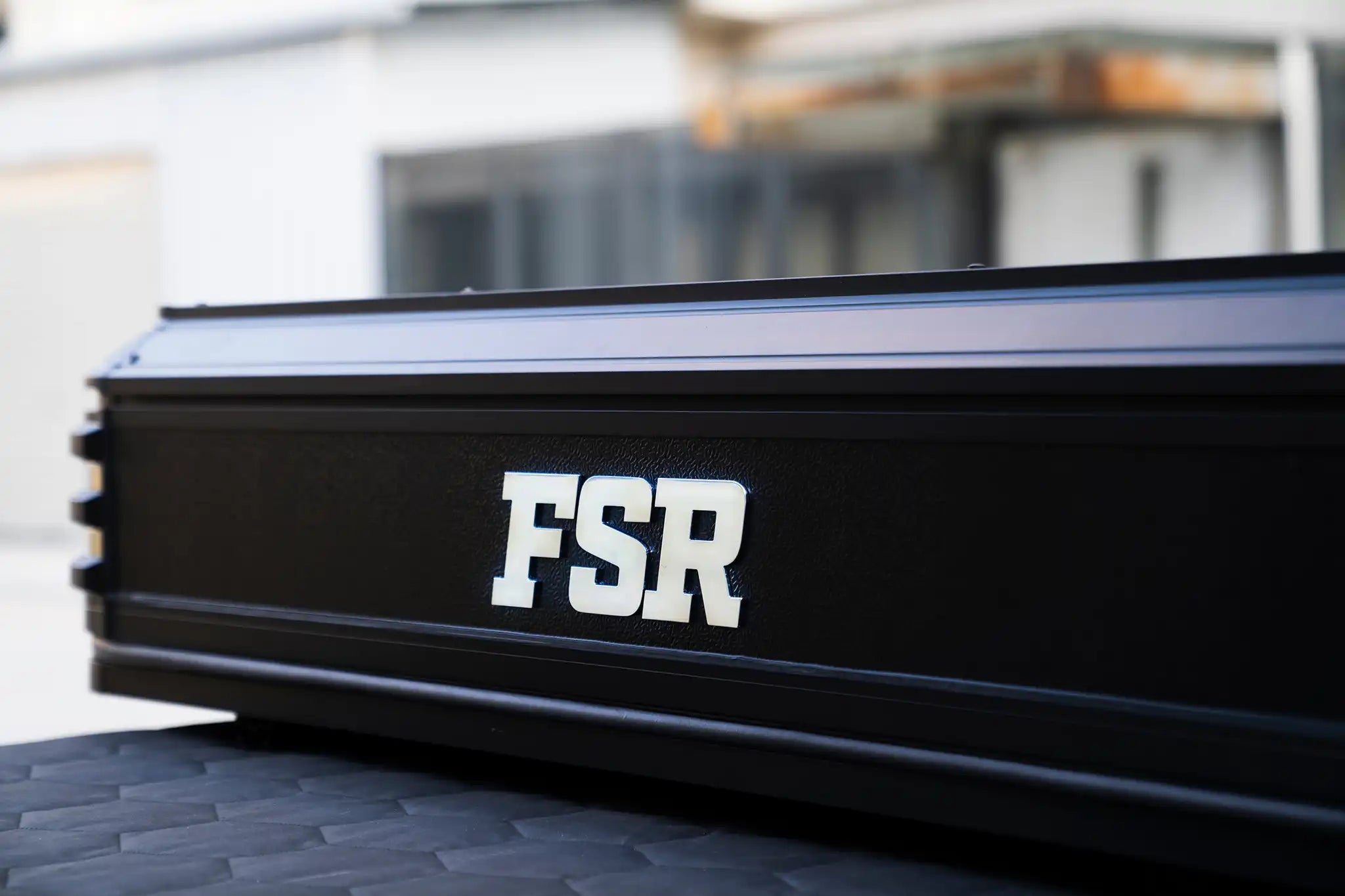Close-up image of the exterior aluminum clam shell and extruded aluminum framing  of the Kali King premium rooftop tent from Freespirit Recreation with 'FSR' branding visible
