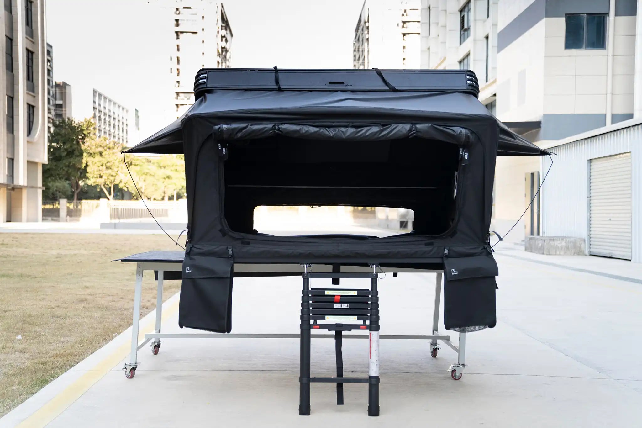 Front-facing Image of the FSR Kali King hard shell rooftop tent from Freespirit Recreation fully deployed with door and windows open.
