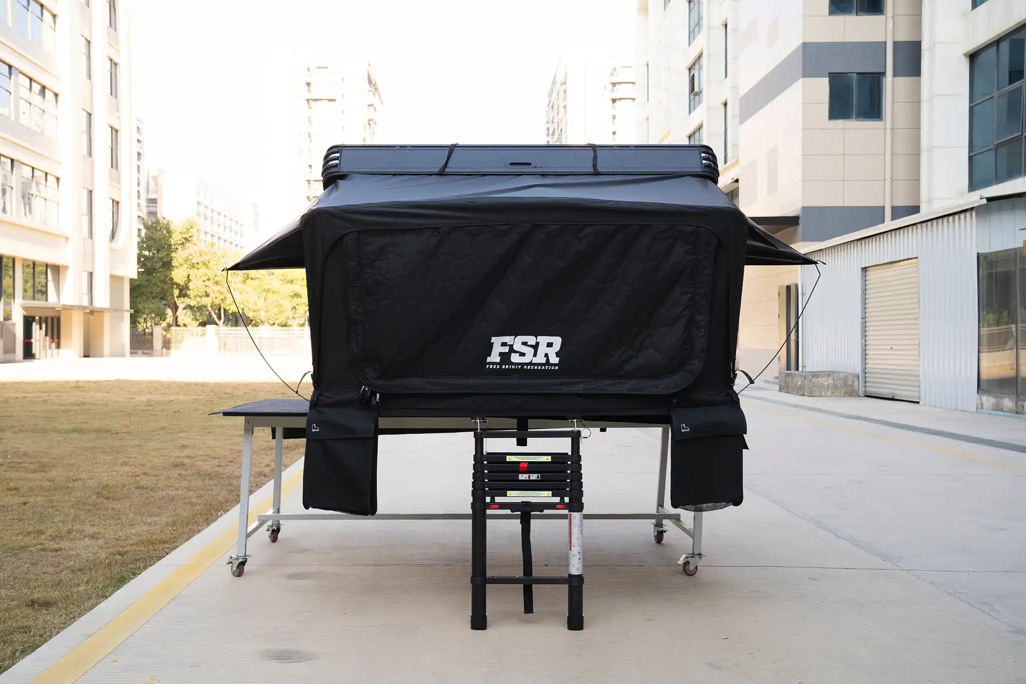 Front-facing Image of the FSR Kali King hard shell rooftop tent from Freespirit Recreation fully deployed with door and windows closed.