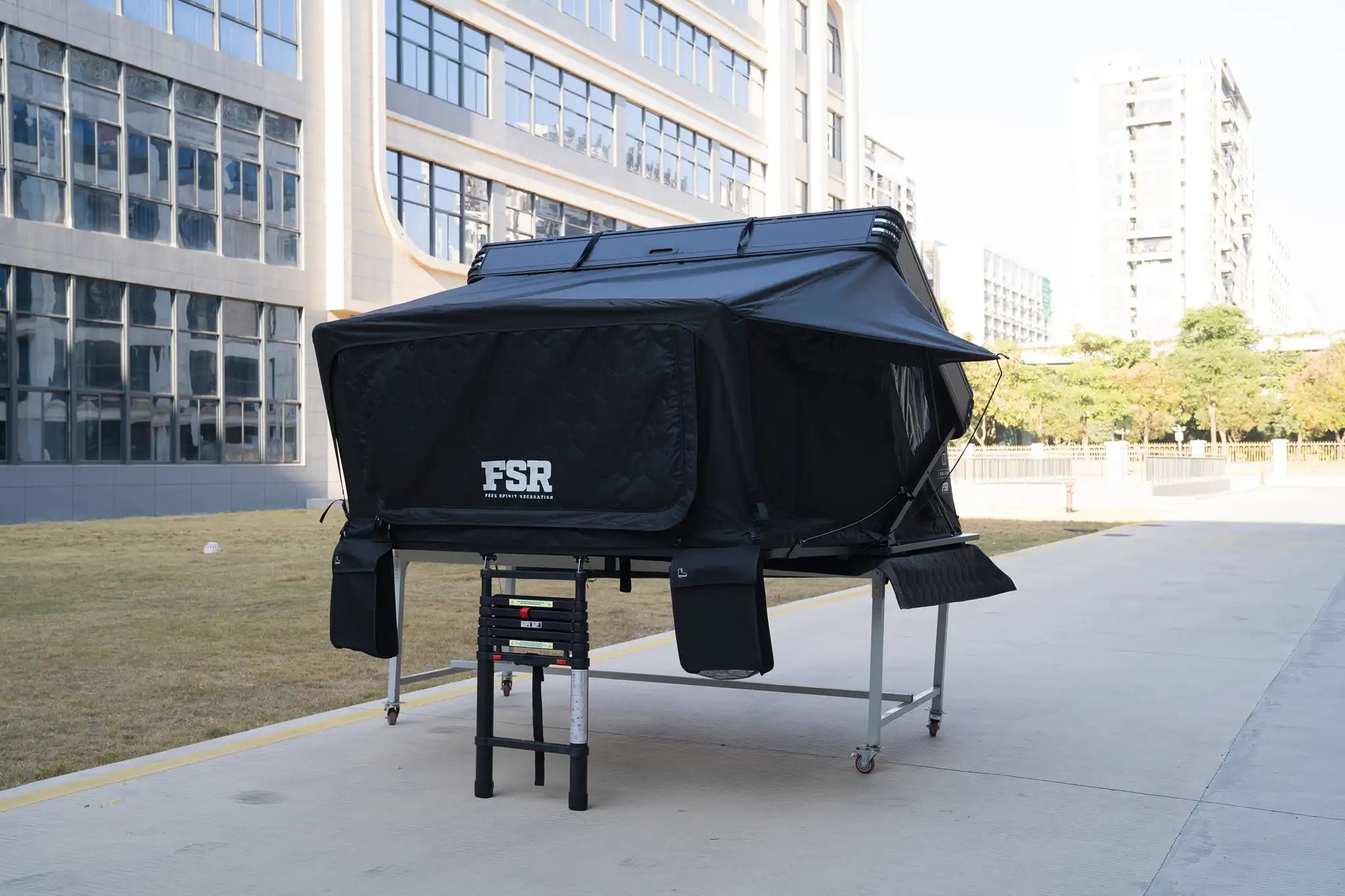 Close-up image of the shoe storage bags and skirt built into the Kali King hard shell rooftop tent from Freespirit Recreation with 'FSR' branding visible on the entry door