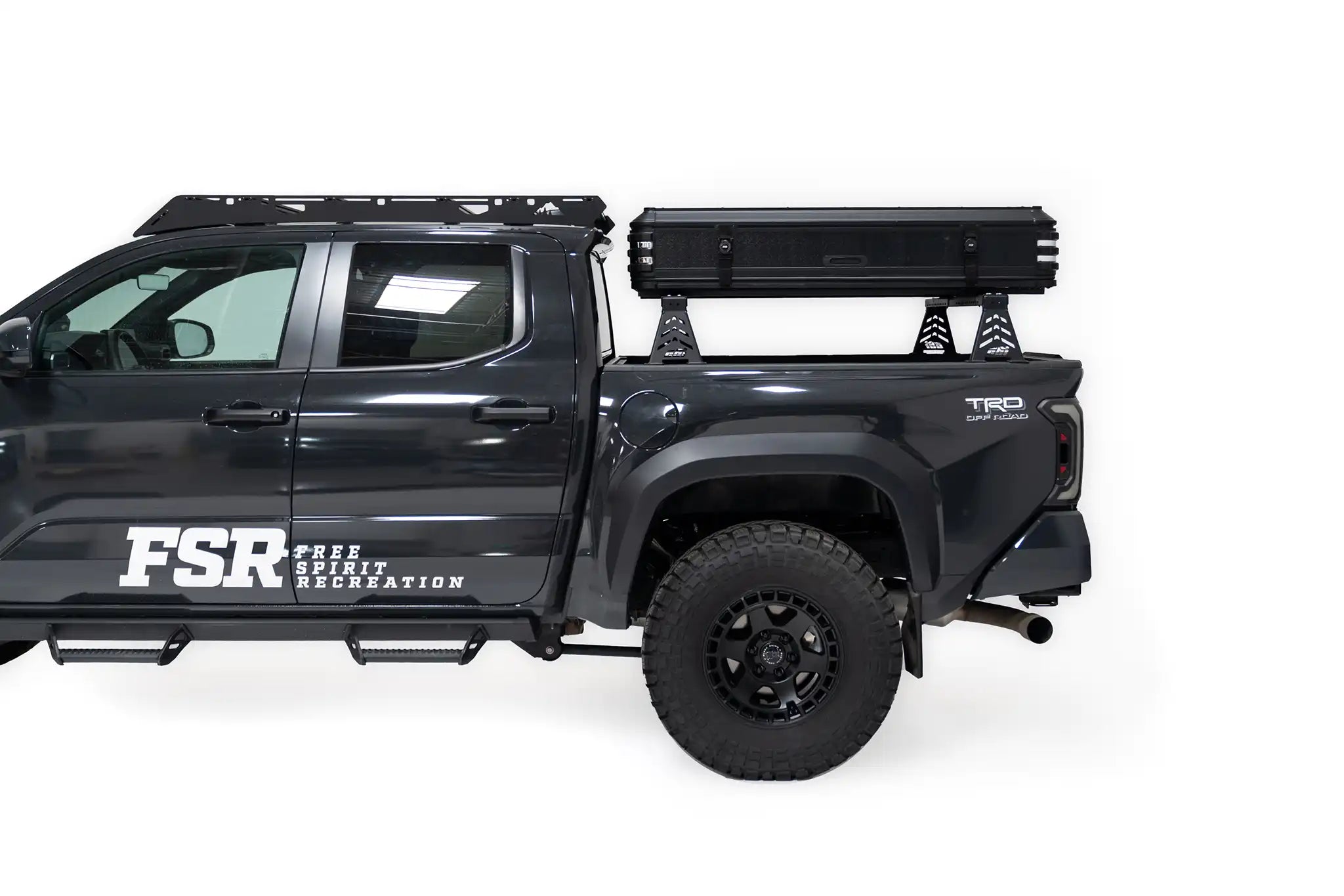 Zoomed out side-profile exterior photo of a closed Kali hardshell rooftop tent by FSR on the truck bed of a 4th gen Toyota Tacoma.