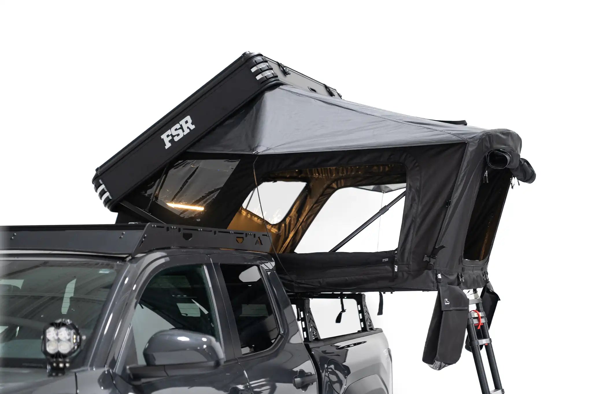 Side-profile exterior photo of Kali hardshell rooftop tent by FSR deployed on a truck bed rack.