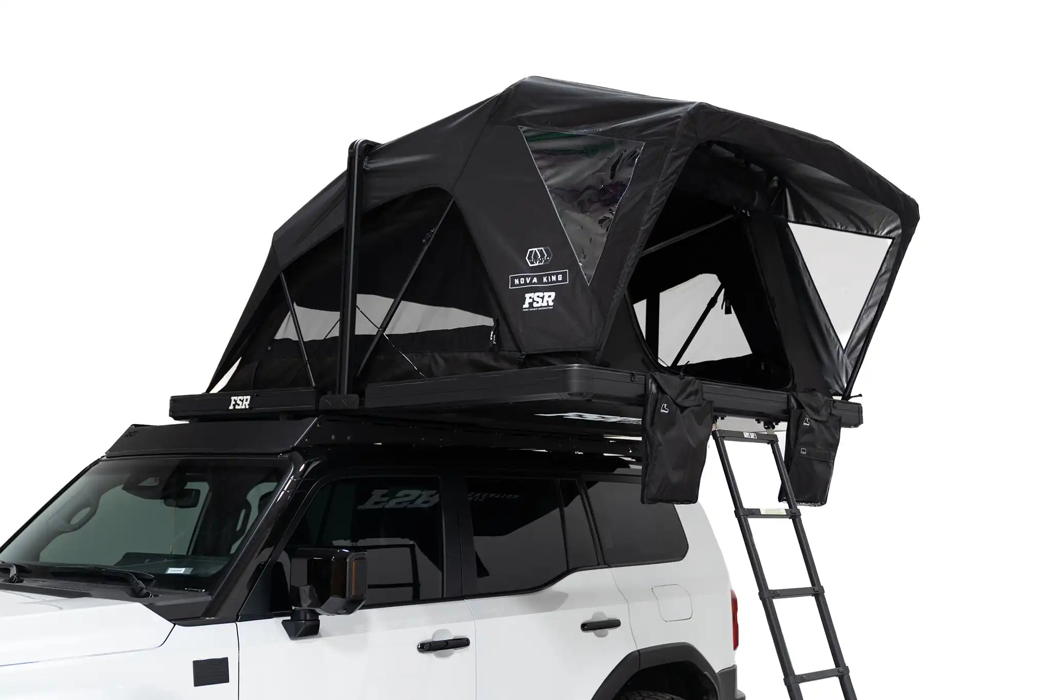 Close-up exterior photo of the Nova King rooftop tent mounted on a white Toyota Land Cruiser with the tent windows and door open.