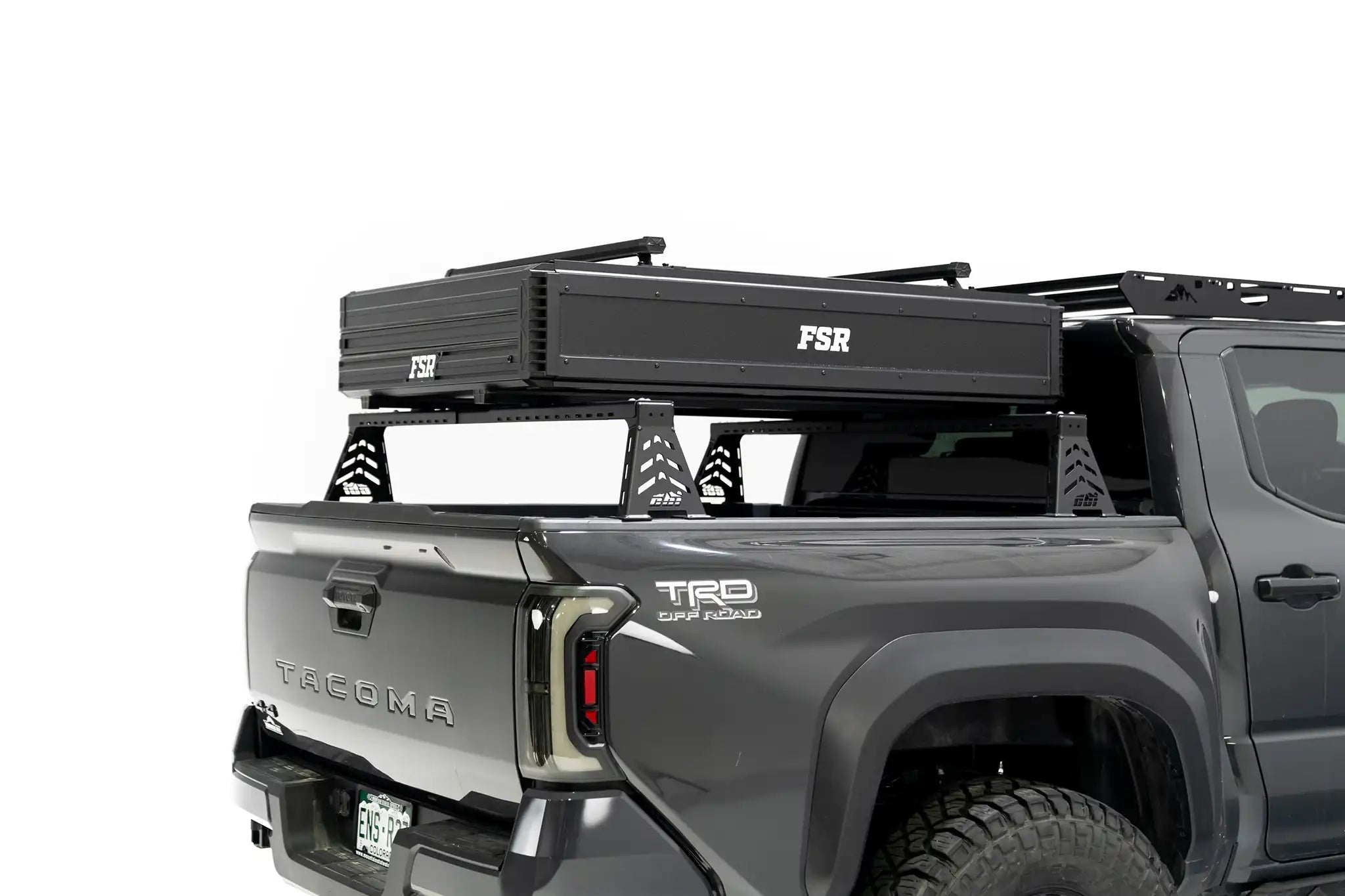 Rear angle photo of FSR Nova rooftop tent closed, mounted on the rear of a black 2025 Toyota Tacoma.