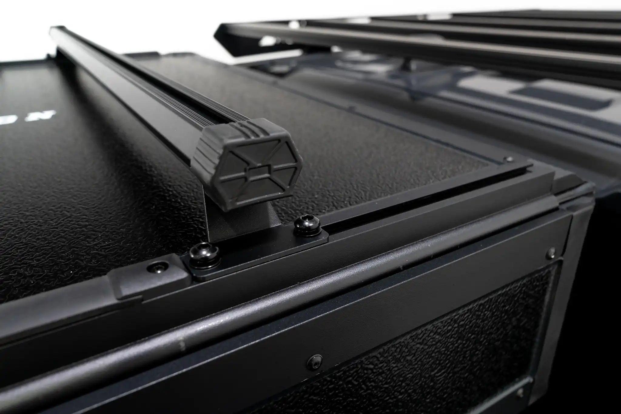 Up close photo of FSR Nova rooftop tent crossbars with tent closed.