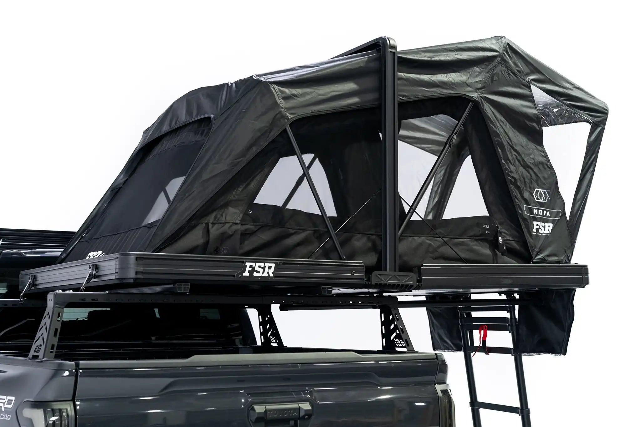Photo of FSR Nova rooftop tent deployed on the rear of a 2025 Toyota Tacoma with the tent windows and doors open.