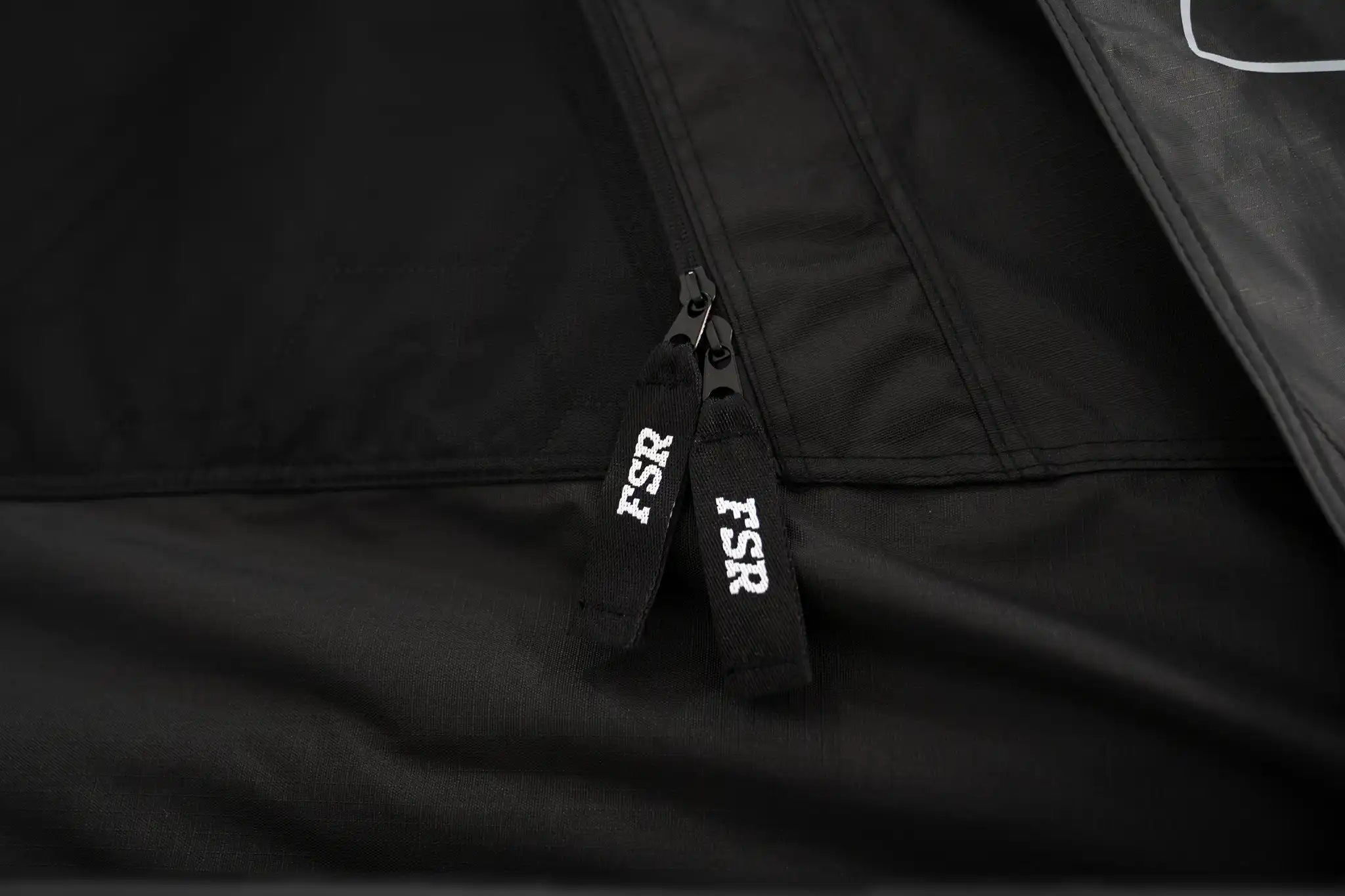 Close-up photo of the FSR branded zippers on the FSR Nova rooftop tent. 