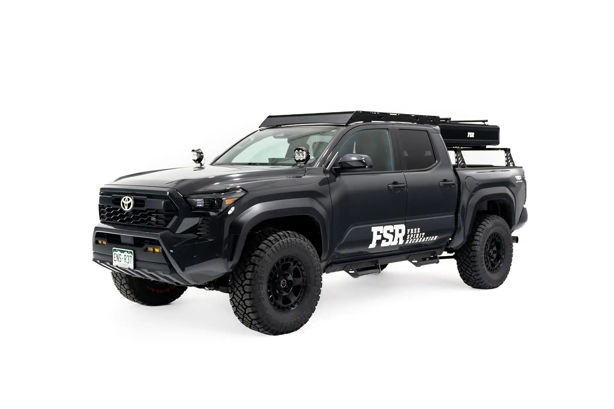 Photo of FSR Nova Standard Tri-Layer rooftop tent closed on the rear of a black 2025 Toyota Tacoma.