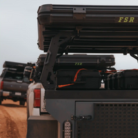 FSR rooftop tent mounting hardware components and replacement parts used to install and maintain various roof tents on off road vehicles and an overland trailer being driven on a desert road.