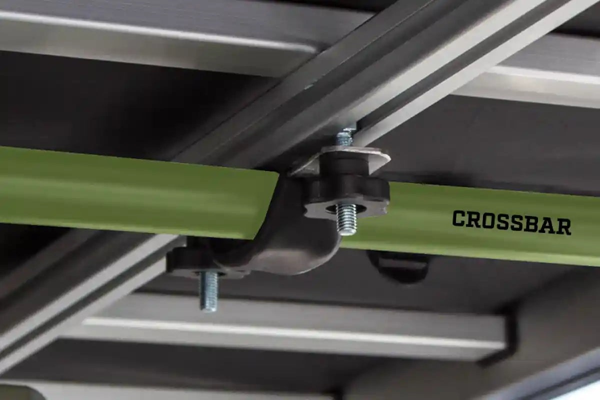 Example of the Freespirit Recreation rooftop tent mounting bracket and hardware installed on a roof rack crossbar