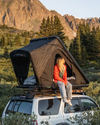 FSR Rooftop Tent setup on an SUV in a dispersed alpine campsite with snow-capped mountains in the background | Free Spirit Recreation
