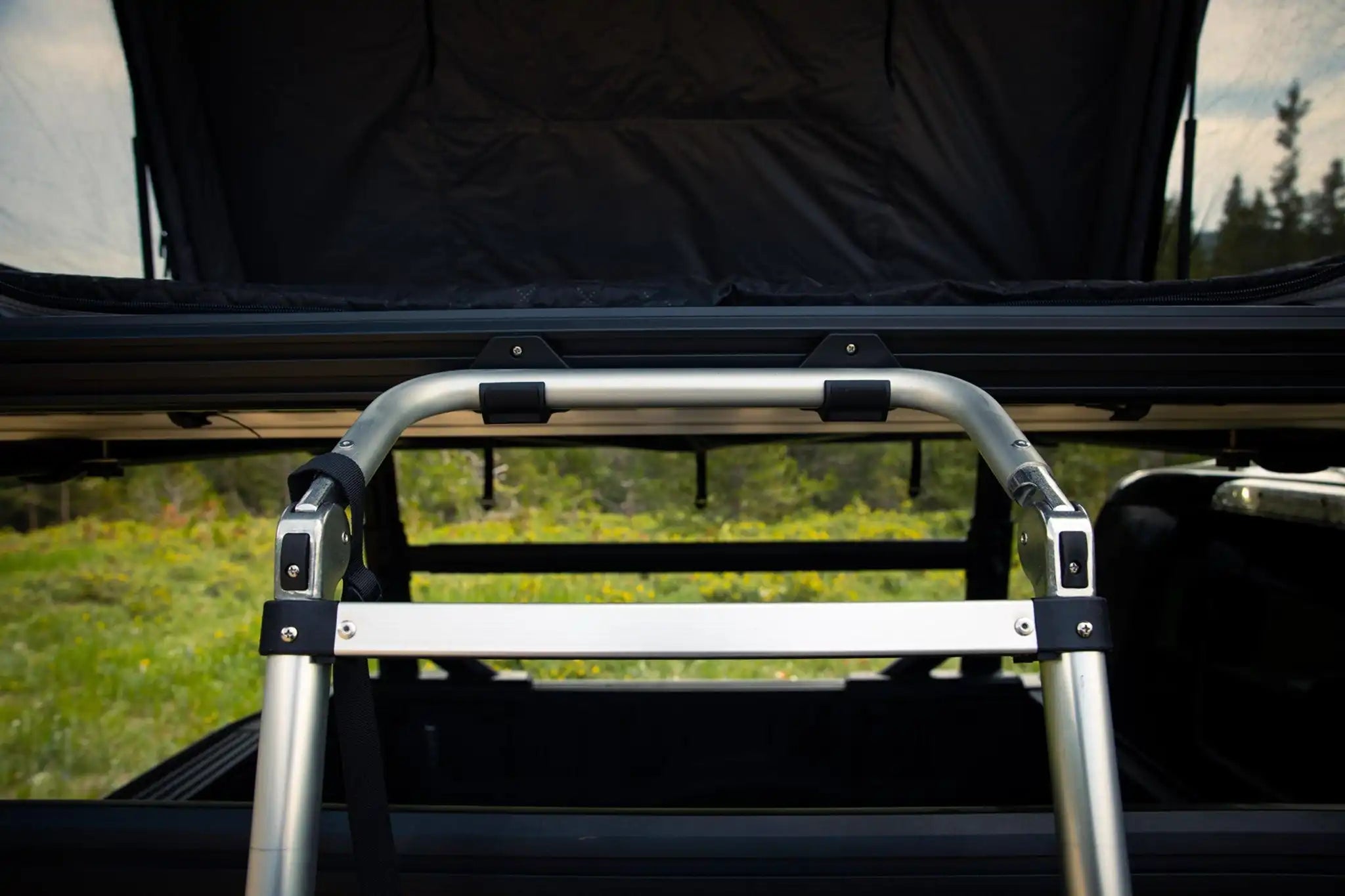 FSR Rooftop Tent Ladder Mounts being used to secure an FSR telescoping roof top tent ladder to the Freespirit Recreation Evolution Rooftop Tent while camping