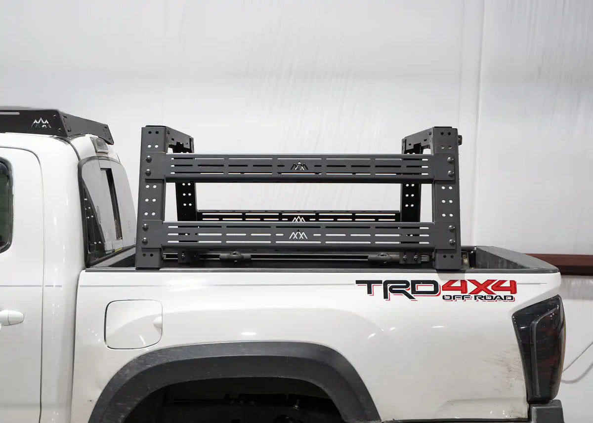 White Toyota Tacoma with a Backwoods Adventure Mods Bed Rack installed as part of a FSR Rooftop Tent Bundle | Free Spirit Recreation